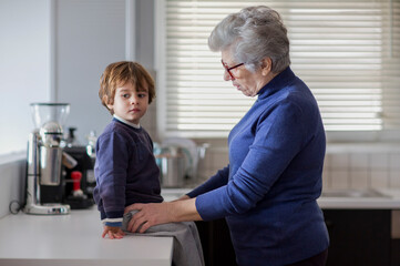 Grandmother and grandson enjoying time together in the kitchen