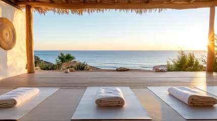 serene wellness retreat by ocean with yoga mats and beautiful sunset
