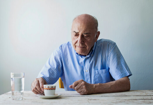 Senior man enjoying a quiet moment with coffee at home - Powered by Adobe