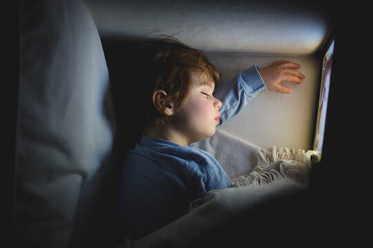 Kid sleeping peacefully in a cozy space at night