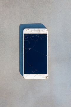 A mobile phone on a gray background