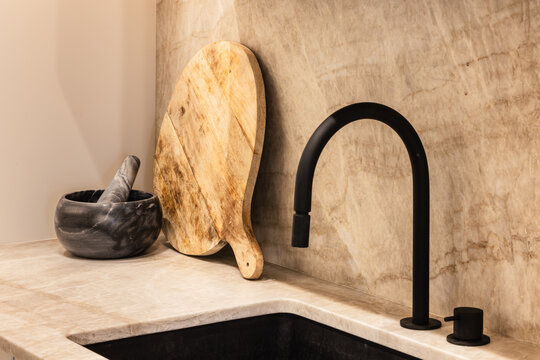 Modern kitchen with black faucet and wooden accents