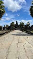 Fototapeta premium Angkor Archaeological Park, Siem Reap, Cambodia. Stone road leading to the historical complex of Angkor Wat
