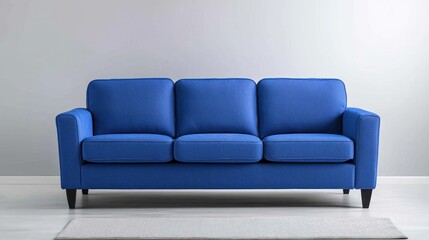 Fototapeta premium Modern Blue Three-Seater Sofa in Minimalist Living Room