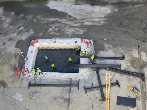 multiple workers install rebar reinforcements
