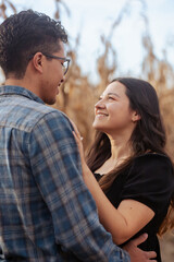 Fototapeta premium Young couple in the countryside looking into each other's eyes