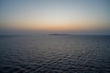 Serene ocean view at sunset with calm waters.
