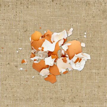 Pile of broken eggshell on linen background
