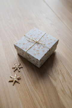 Present box tied with bow and decorated with straw stars