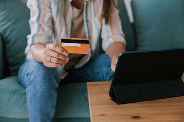 Woman Using a Tablet for Online Shopping with a Credit Card
