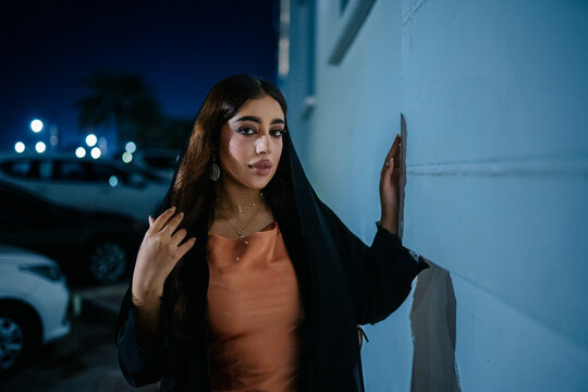 Elegant muslim woman posing at night in parking lot