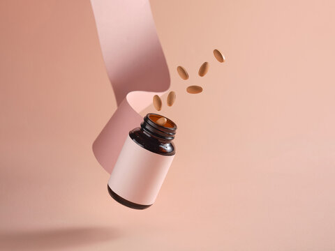 Floating Medicine Bottle With Pills Against a Gradient Background