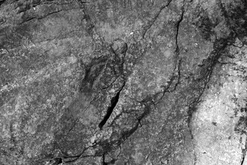 Black grey rock texture. Rough mountain surface with cracks. Close-up. Dark stone background with space for design Grunge Banner Wide