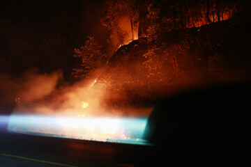 Nighttime Forest Fire Illuminates Roadside