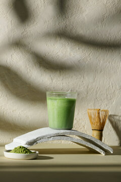 A refreshing green matcha latte placed on a stylish surface