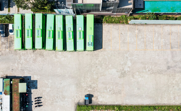 Aerial view of green buses in a parking lot