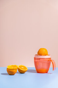 Citrus juicer / squeezer with half-squeezed orange. Making juice. 