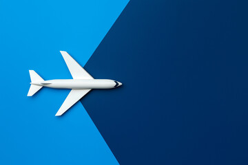 Flat lay design of a white plane isolated on a colorful background
