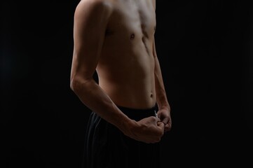 Muscular Male Torso Highlighting Strength and Fitness in Dark Background
