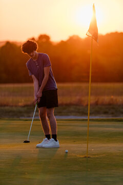 Teenage boy golfing