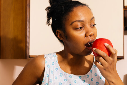 Close up of a woman taking a Bite