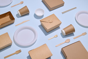 Eco-Friendly Packaging and Utensils Laid Out on Blue Background