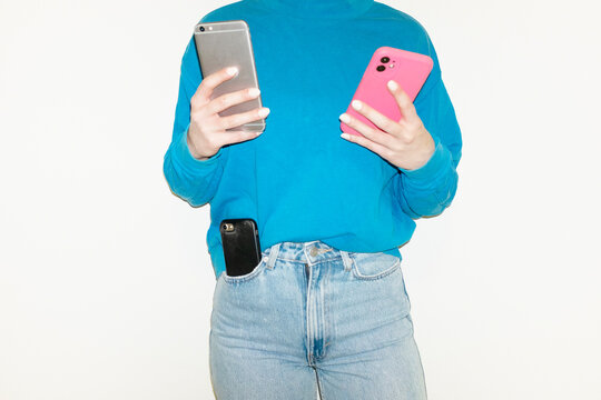 Person with mobile smart phone devices with hard direct flash