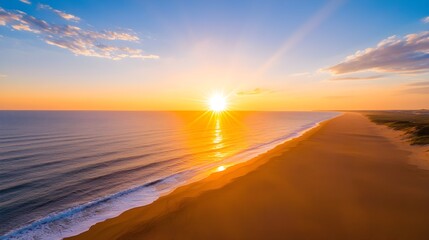 Obraz premium Aerial View of a Sunset Over Sandy Beach and Ocean