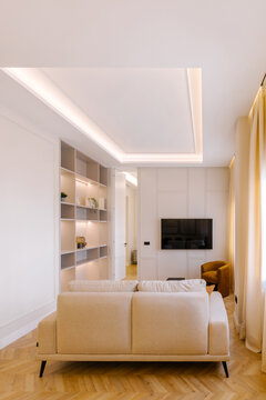Cozy modern living room with sofa and wall-mounted TV