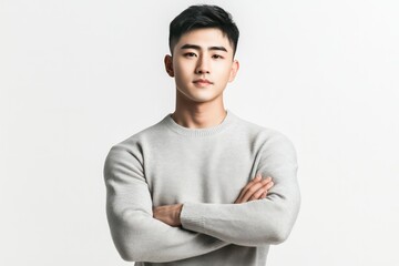 A young Chinese man, wearing a light grey sweater and off-white chinos, natural skin tone, short black hair, with a thoughtful and approachable