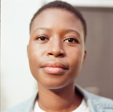 Close up portrait of young woman wearing denim jacket using a TLR