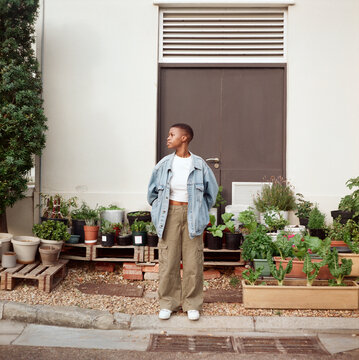 Environmental portrait of young woman wearing denim jacket and pants