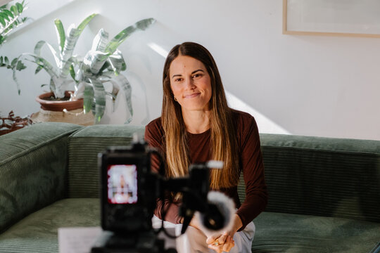 Girl using a professional camera to record videos for internet