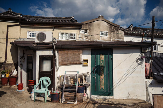 Old house with cheap furniture stashed in front of it