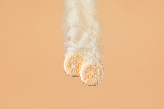 Image of two effervescent tablets dissolving in water