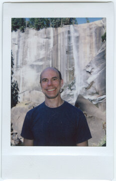 Smiling Man in Front of Waterfall in Yosemite National Park
