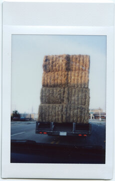 Instant Photograph of Truck Hauling Hay Bales
