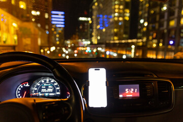 Blank mobile phone screen In Car at night in City skyline 
