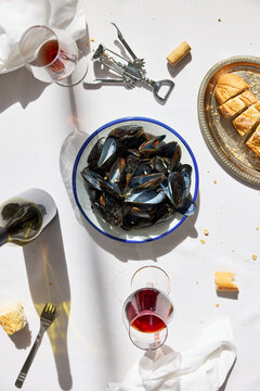 Empty mussels shells in bowl on white table