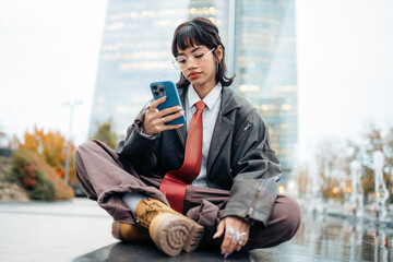 Stilish young businesswoman using smartphone