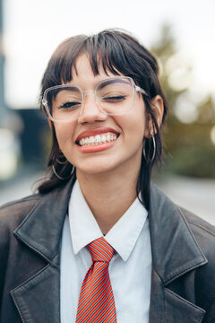 Young woman winking and smiling wearing glasses, shirt,