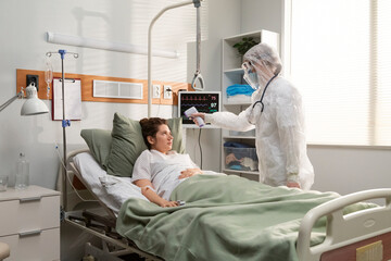 Doctor measuring patient temperature 