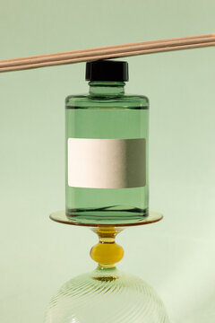 Elegant product mockup featuring a green bottle on a stand