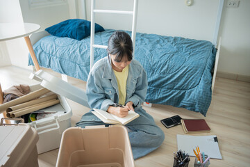 Student asian woman organize room unpack in dorm room college student moving to new  university dormitory or preparing to move out.