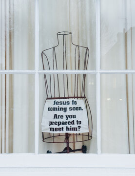 Metal mannequin with faith message in a London window display