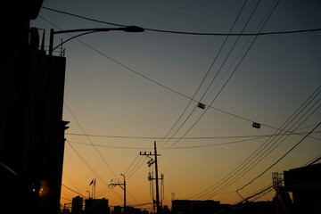 Orange-blue sunset sky over Korean rooftops