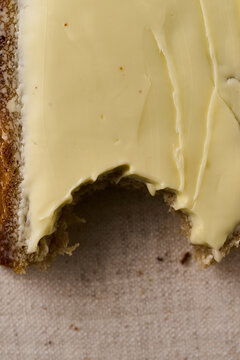 A piece of bread and butter with a bite mark