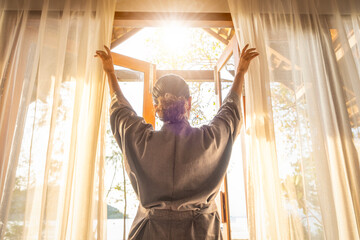 The woman was at the window in the bedroom. She opened the curtains on the window. In the morning...