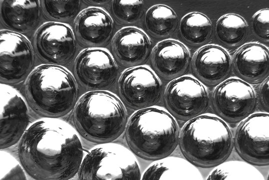 glass nodules bottom of antique bowl, macro closeup