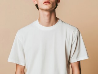 Stylish Male in Plain White Tee Shirt Against Warm Beige Background Simple Fashion Portrait